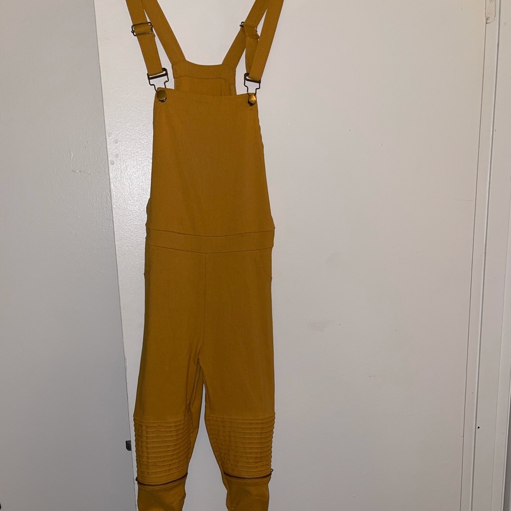 Mustard yellow overalls.